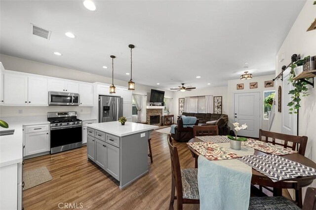 717 Lingel Dr, El Cajon, CA 92019 - kitchen featuring stainless steel appliances, light countertops, gray cabinetry, ceiling fan, and pendant lighting