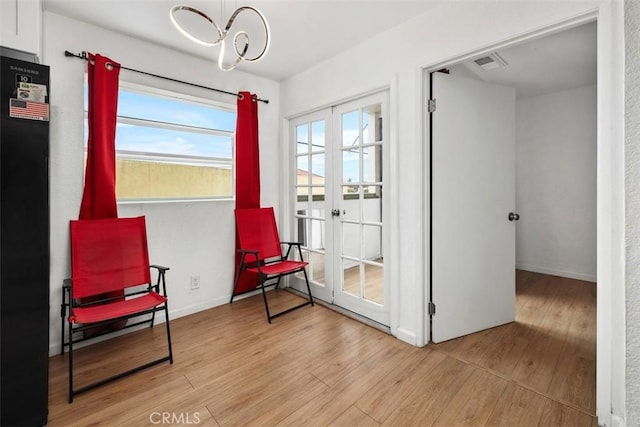 3142 Midway Dr Unit 312, San Diego, CA 92110 - sitting room with wood finished floors, a chandelier, and french doors