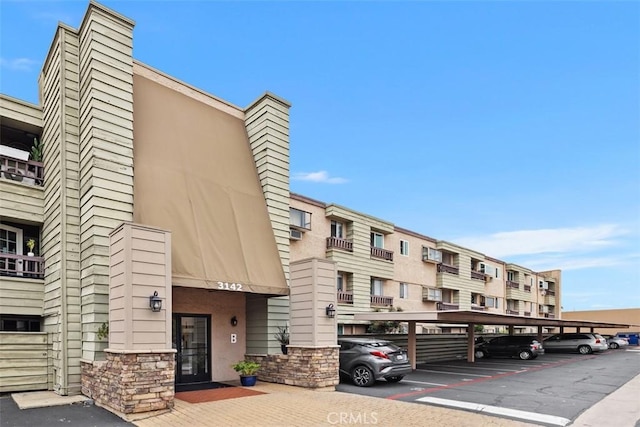3142 Midway Dr Unit 312, San Diego, CA 92110 - view of building exterior featuring covered parking