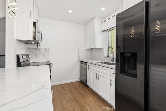 3142 Midway Dr Unit 312, San Diego, CA 92110 - kitchen featuring appliances with stainless steel finishes, light wood-style flooring, tasteful backsplash, white cabinetry, and recessed lighting