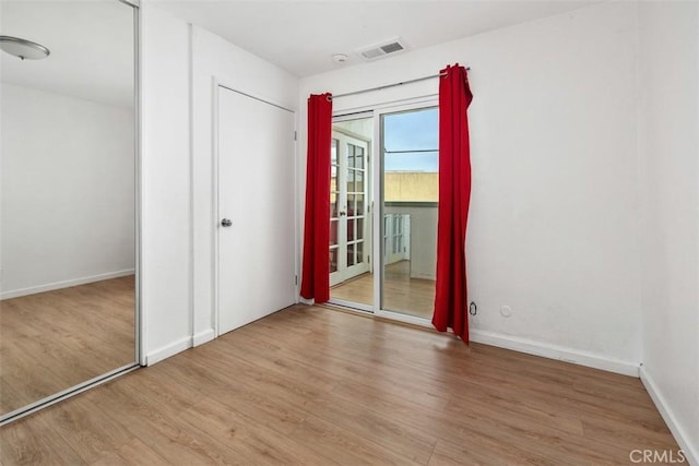3142 Midway Dr Unit 312, San Diego, CA 92110 - unfurnished bedroom featuring wood finished floors and access to exterior