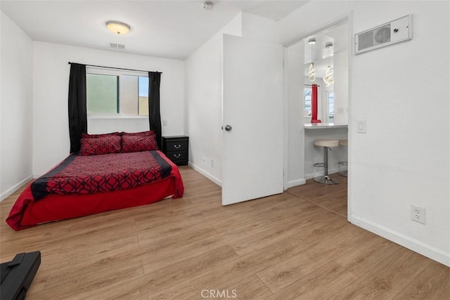3142 Midway Dr Unit 312, San Diego, CA 92110 - bedroom with wood finished floors and connected bathroom