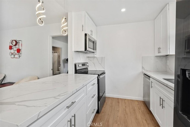 3142 Midway Dr Unit 312, San Diego, CA 92110 - kitchen featuring appliances with stainless steel finishes, light wood-style floors, decorative backsplash, white cabinetry, and recessed lighting