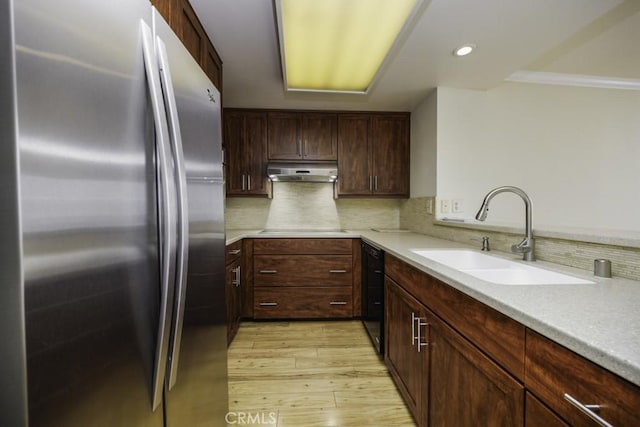 700 E Ocean Blvd Unit 2606, Long Beach, CA 90802 - kitchen featuring black appliances, light wood-style flooring, under cabinet range hood, decorative backsplash, and light countertops