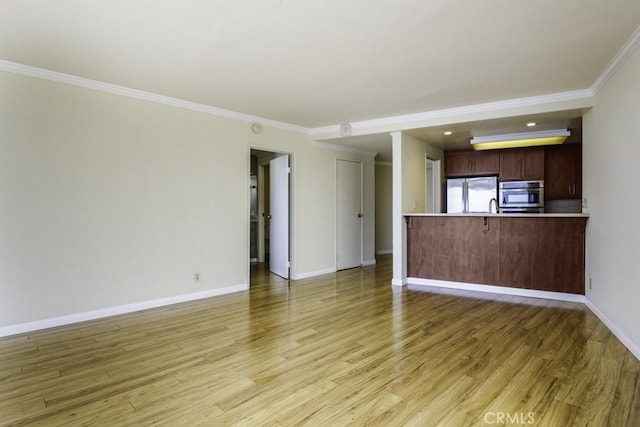 700 E Ocean Blvd Unit 2606, Long Beach, CA 90802 - unfurnished living room featuring ornamental molding and light wood-type flooring