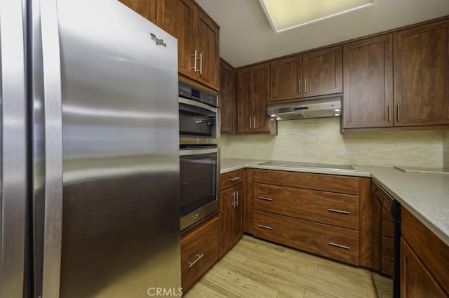 700 E Ocean Blvd Unit 2606, Long Beach, CA 90802 - kitchen featuring stainless steel appliances, under cabinet range hood, light wood-type flooring, and tasteful backsplash