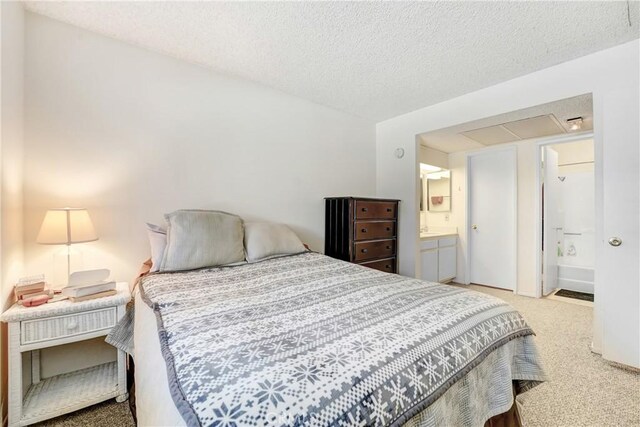 4565 Alamo St Unit H, Simi Valley, CA 93063 - bedroom with carpet flooring, a textured ceiling, and ensuite bath