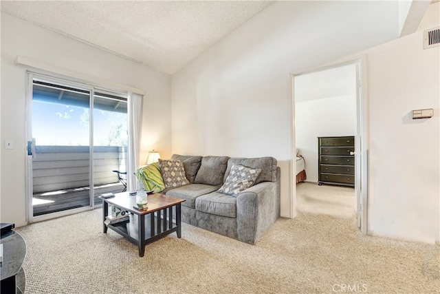 4565 Alamo St Unit H, Simi Valley, CA 93063 - carpeted living area featuring vaulted ceiling and a textured ceiling