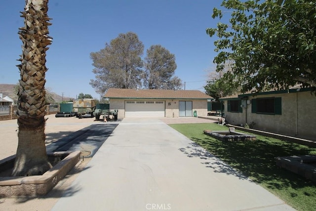 38103 Dividing Line St, Yermo, CA 92398 - single story home featuring a garage, stucco siding, and driveway
