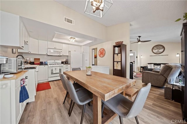 28927 Rue Daniel Cyn, Country, CA 91387 - dining room featuring light wood-type flooring, ceiling fan, and a textured ceiling