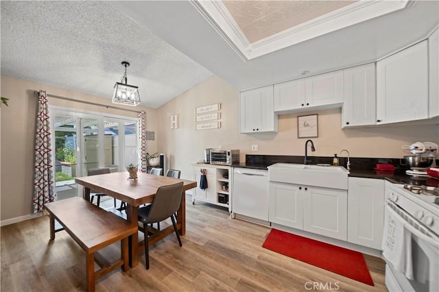 28927 Rue Daniel Cyn, Country, CA 91387 - kitchen featuring white appliances, dark countertops, light wood-style flooring, white cabinetry, and hanging light fixtures
