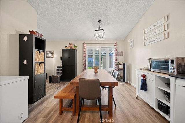 28927 Rue Daniel Cyn, Country, CA 91387 - dining room featuring a textured ceiling, light wood-style flooring, and a chandelier