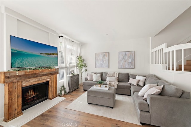 36 Via Madera, Rancho Santa Margarita, CA 92688 - living area with wood finished floors, a lit fireplace, and stairway