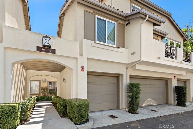 36 Via Madera, Rancho Santa Margarita, CA 92688 - townhome / multi-family property featuring a balcony, stucco siding, and an attached garage