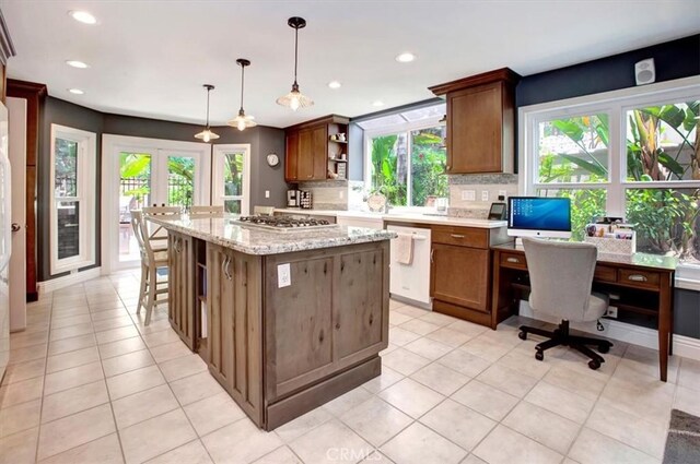 26181 San Marino Ct, Mission Viejo, CA 92692 - kitchen with white dishwasher, open shelves, tasteful backsplash, a kitchen island, and plenty of natural light