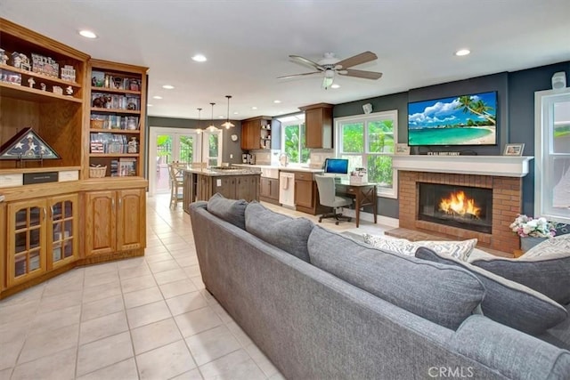 26181 San Marino Ct, Mission Viejo, CA 92692 - living room with light tile patterned floors, recessed lighting, a ceiling fan, a brick fireplace, and an office area