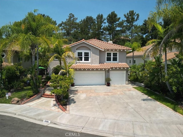 26181 San Marino Ct, Mission Viejo, CA 92692 - mediterranean / spanish house with a tile roof, stucco siding, driveway, and an attached garage