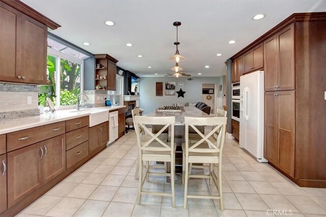 26181 San Marino Ct, Mission Viejo, CA 92692 - kitchen featuring white appliances, recessed lighting, open floor plan, open shelves, and tasteful backsplash