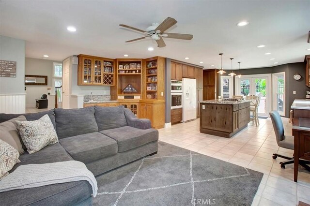 26181 San Marino Ct, Mission Viejo, CA 92692 - living room with bar with sink, recessed lighting, light tile patterned floors, and ceiling fan