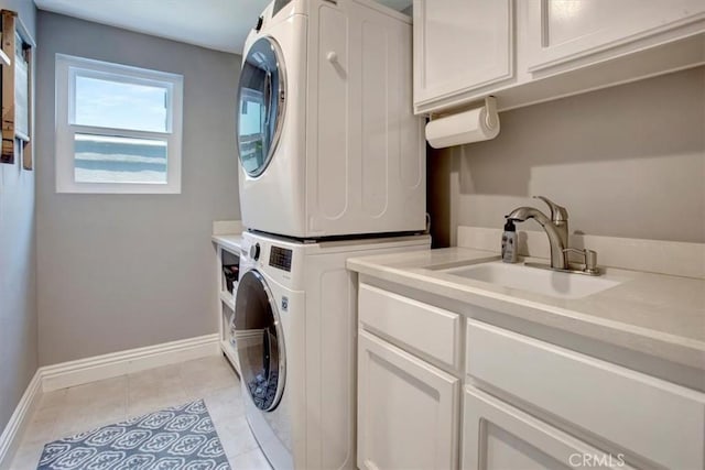 26181 San Marino Ct, Mission Viejo, CA 92692 - washroom featuring stacked washer and clothes dryer, cabinet space, and light tile patterned floors