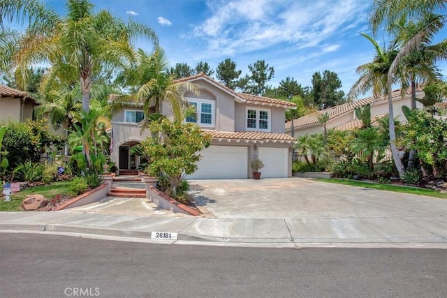 26181 San Marino Ct, Mission Viejo, CA 92692 - mediterranean / spanish-style house featuring a tile roof, stucco siding, driveway, and a garage