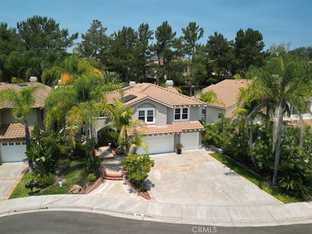 26181 San Marino Ct, Mission Viejo, CA 92692 - view of front of house with a tiled roof, concrete driveway, stucco siding, and a garage