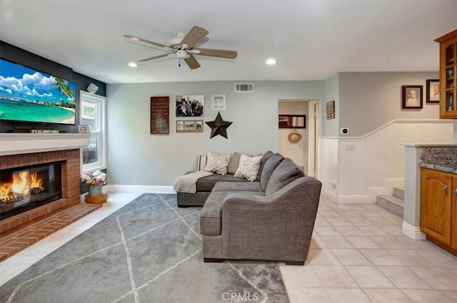 26181 San Marino Ct, Mission Viejo, CA 92692 - living room featuring a ceiling fan, a fireplace, recessed lighting, a wainscoted wall, and light tile patterned floors
