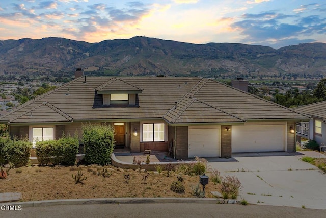 800 Manor Ridge Rd, Santa Paula, CA 93060 - traditional-style home featuring a chimney, concrete driveway, a mountain view, a garage, and brick siding