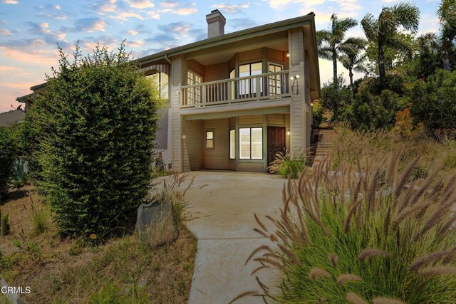 800 Manor Ridge Rd, Santa Paula, CA 93060 - view of front of property with a balcony, a chimney, a patio area, and concrete driveway