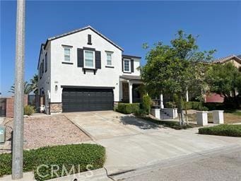 4866 Stoneglen Ave, Fontana, CA 92336 - view of front of property with driveway, an attached garage, and stucco siding