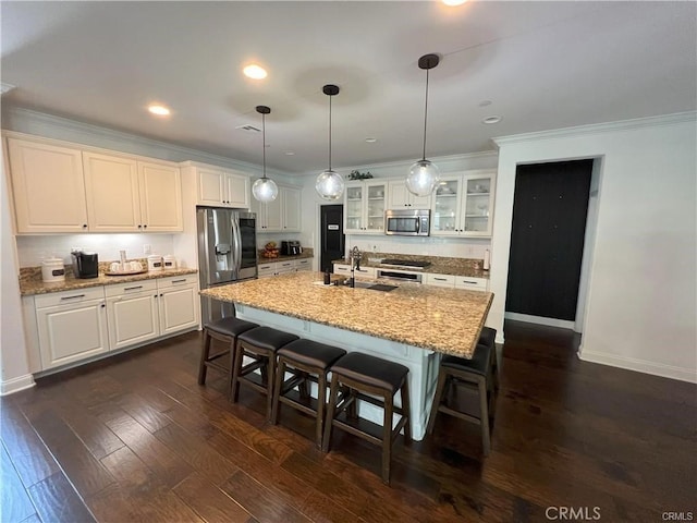 4866 Stoneglen Ave, Fontana, CA 92336 - kitchen featuring appliances with stainless steel finishes, a kitchen breakfast bar, white cabinetry, ornamental molding, and glass insert cabinets
