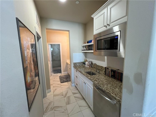 4866 Stoneglen Ave, Fontana, CA 92336 - kitchen with stainless steel appliances, dark stone countertops, white cabinetry, light marble finish floors, and open shelves