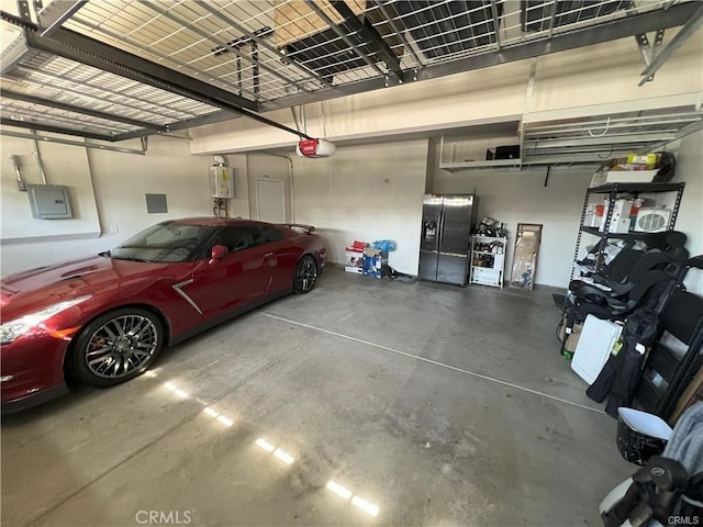 4866 Stoneglen Ave, Fontana, CA 92336 - garage with stainless steel refrigerator with ice dispenser, a garage door opener, electric panel, and water heater