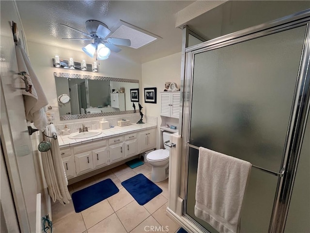 1271 Kenwood Rd Unit M7-J, Seal Beach, CA 90740 - bathroom with ceiling fan, decorative backsplash, tile patterned floors, vanity, and a stall shower