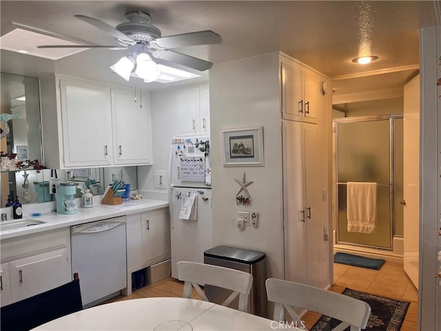 1271 Kenwood Rd Unit M7-J, Seal Beach, CA 90740 - kitchen featuring white appliances, ceiling fan, white cabinetry, light countertops, and light tile patterned floors