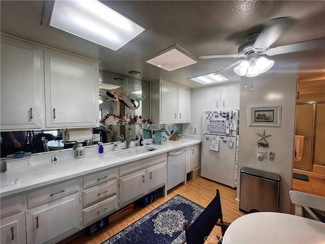 1271 Kenwood Rd Unit M7-J, Seal Beach, CA 90740 - kitchen featuring white appliances, ceiling fan, light wood-style floors, light countertops, and white cabinets