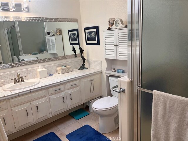 1271 Kenwood Rd Unit M7-J, Seal Beach, CA 90740 - bathroom with tile patterned floors, vanity, a shower stall, and backsplash