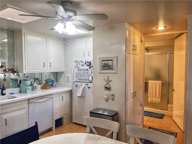 1271 Kenwood Rd Unit M7-J, Seal Beach, CA 90740 - kitchen featuring white appliances, ceiling fan, white cabinetry, light countertops, and light tile patterned flooring