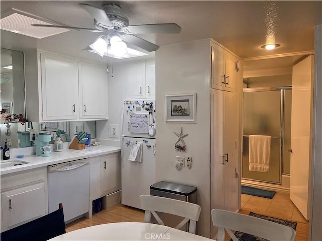 1271 Kenwood Rd Unit M7-J, Seal Beach, CA 90740 - kitchen featuring white appliances, ceiling fan, white cabinetry, light countertops, and light tile patterned floors