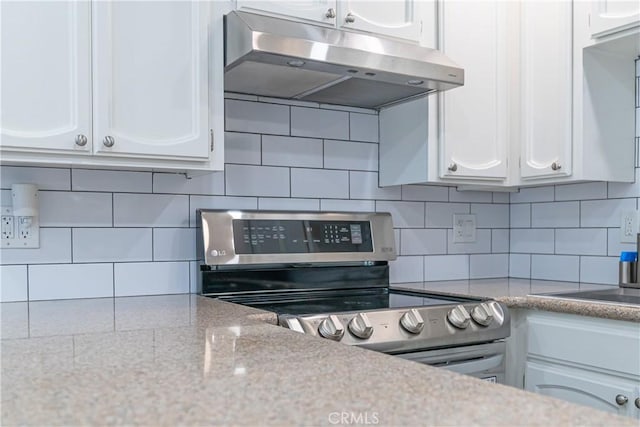 1845 Anaheim Ave Unit 27, Costa Mesa, CA 92627 - kitchen with under cabinet range hood, stainless steel electric stove, white cabinetry, and decorative backsplash