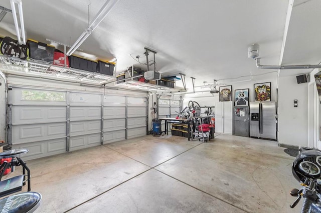 27792 Elderberry St, Murrieta, CA 92562 - garage with stainless steel fridge and a garage door opener