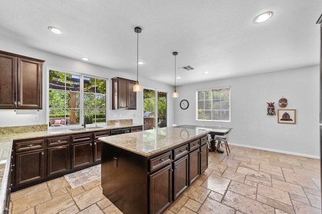 27792 Elderberry St, Murrieta, CA 92562 - kitchen featuring stone tile flooring, light stone countertops, recessed lighting, decorative light fixtures, and a kitchen island
