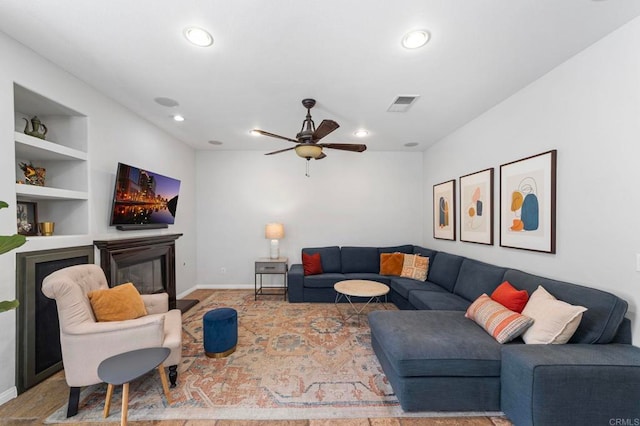 27792 Elderberry St, Murrieta, CA 92562 - living area featuring a glass covered fireplace, recessed lighting, ceiling fan, and built in shelves