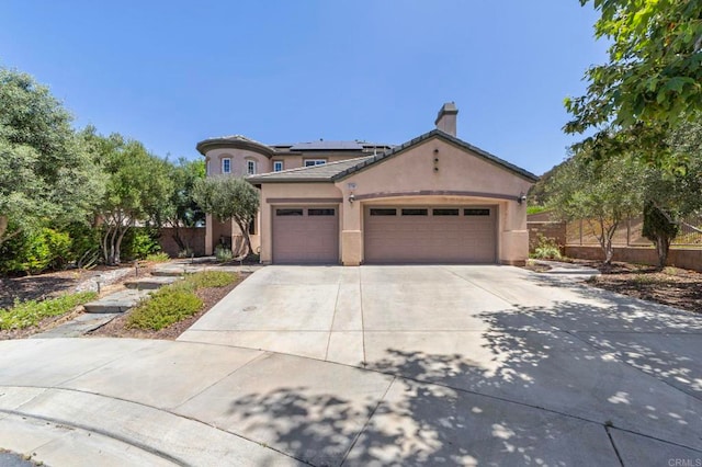 27792 Elderberry St, Murrieta, CA 92562 - view of front of home featuring roof mounted solar panels, an attached garage, driveway, stucco siding, and a chimney