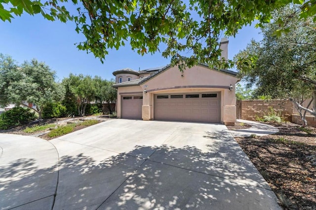 27792 Elderberry St, Murrieta, CA 92562 - view of front facade with solar panels, concrete driveway, an attached garage, and stucco siding