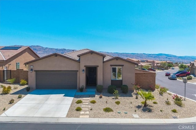 11588 Sky Pointe Dr, Desert Hot Springs, CA 92240 - ranch-style home featuring a mountain view, an attached garage, stucco siding, driveway, and a tiled roof