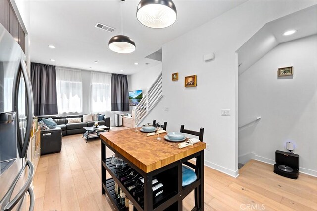 206 Alamo Ct, Long Beach, CA 90802 - dining area with light wood-type flooring, stairs, and recessed lighting