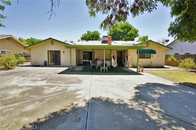 1200 Oxford Way, Hanford, CA 93230 - back of property with a patio area, stucco siding, and a chimney