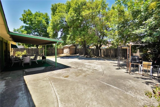 1200 Oxford Way, Hanford, CA 93230 - fenced backyard featuring a storage unit and a patio area