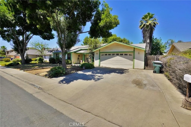 1200 Oxford Way, Hanford, CA 93230 - ranch-style house with concrete driveway, stucco siding, an attached garage, and a residential view